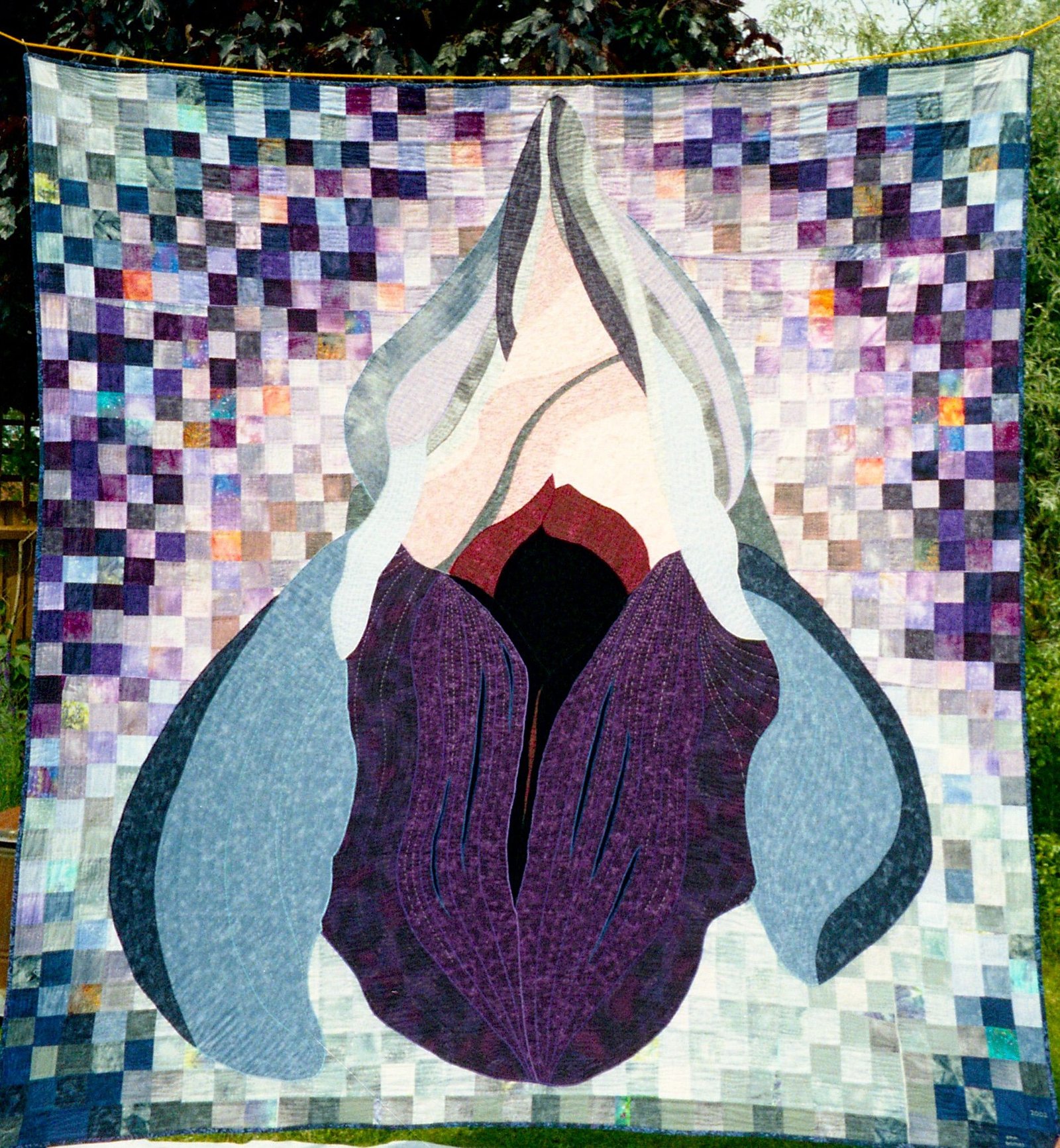 Patchwork quilt detail representing the UFO Clinic